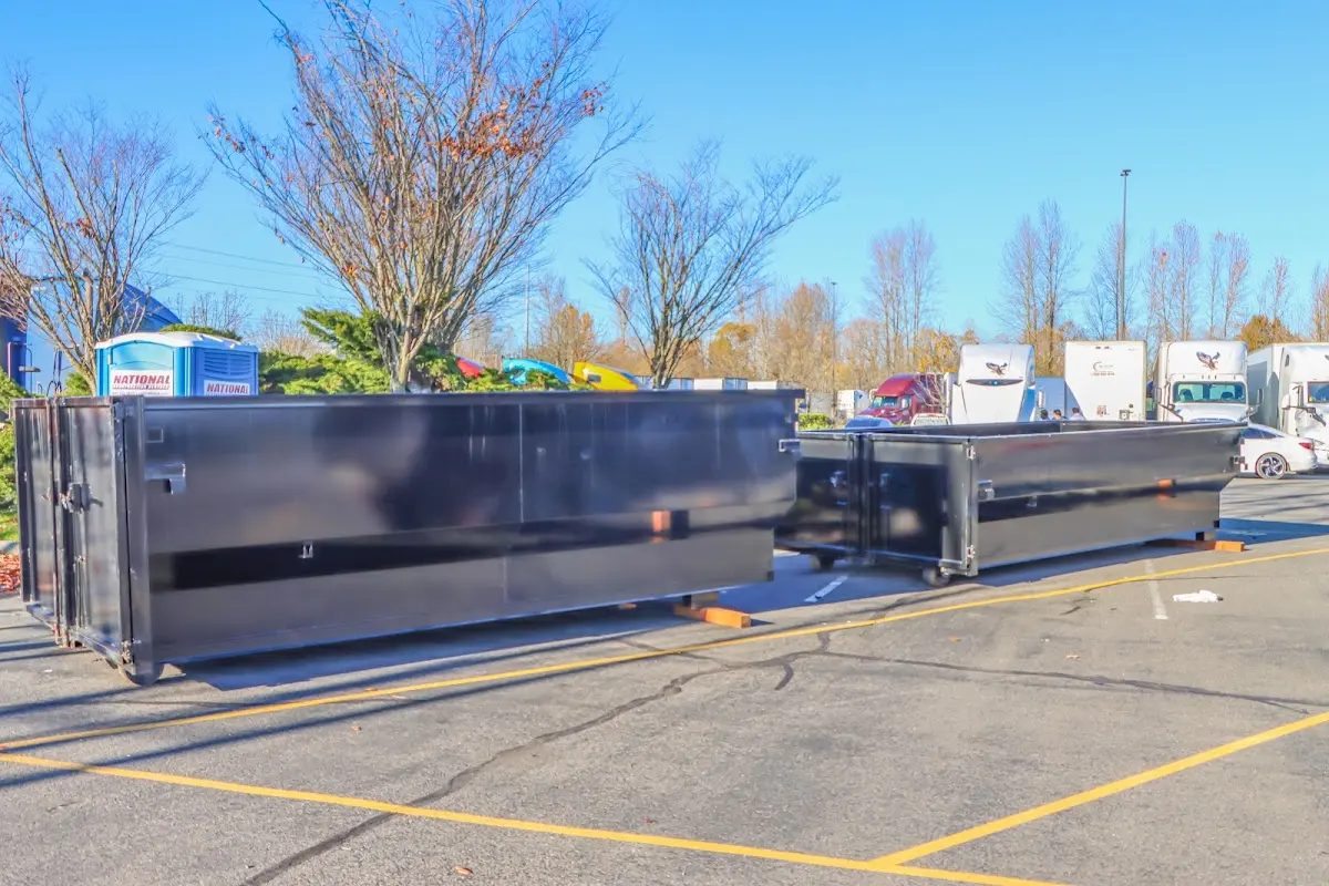 Professional dumpster rental service with roll-off container on residential driveway in Arvada